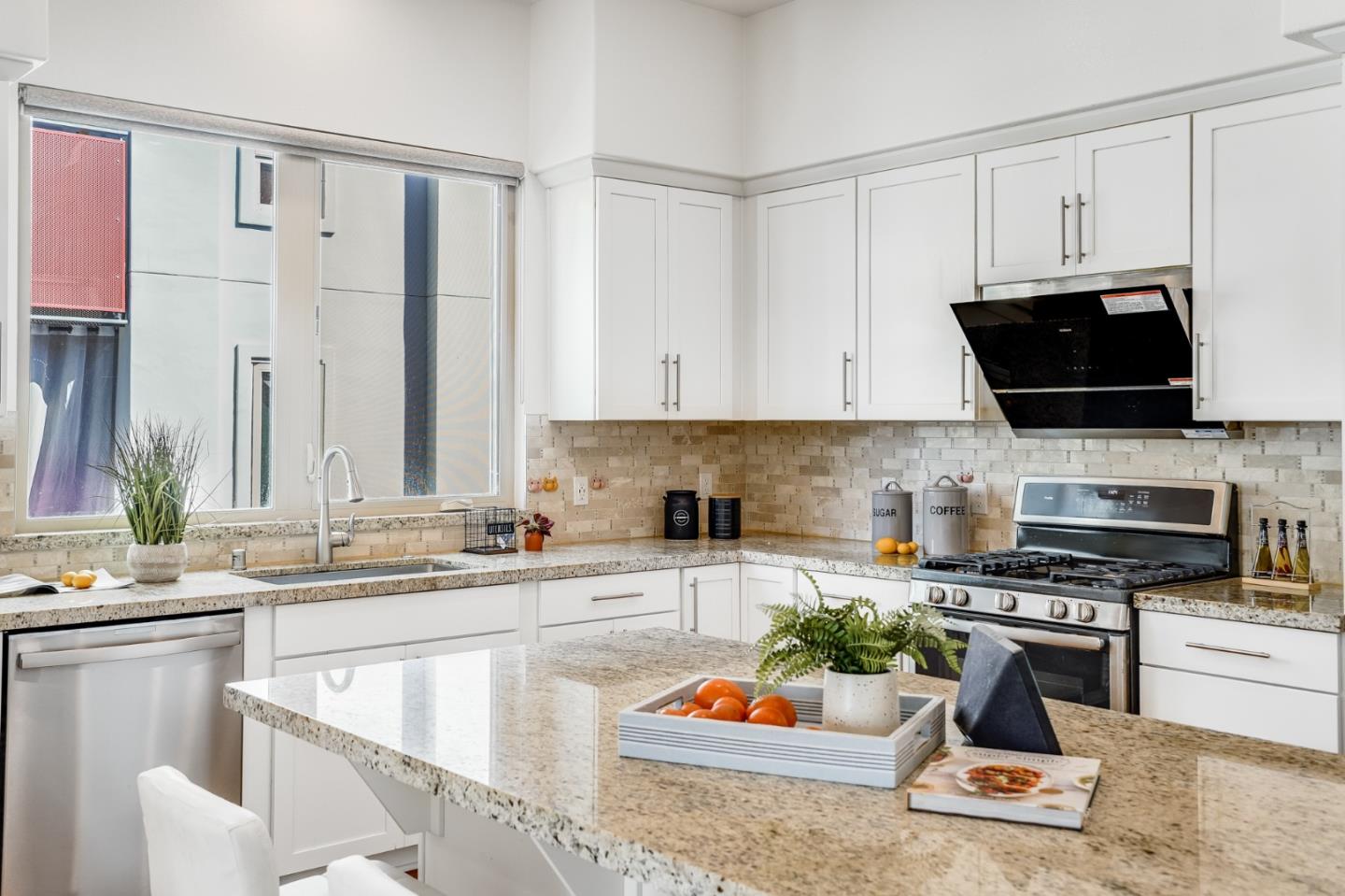 360 Riesling Avenue, Unit 32 Milpitas, CA 95035 - Photo 10 of 32 a kitchen with stainless steel appliances a stove a sink a microwave and cabinets