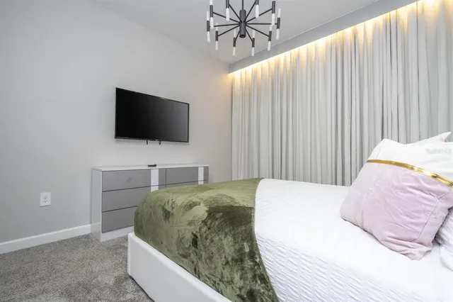 a kitchen with kitchen island granite countertop a sink cabinets and stainless steel appliances