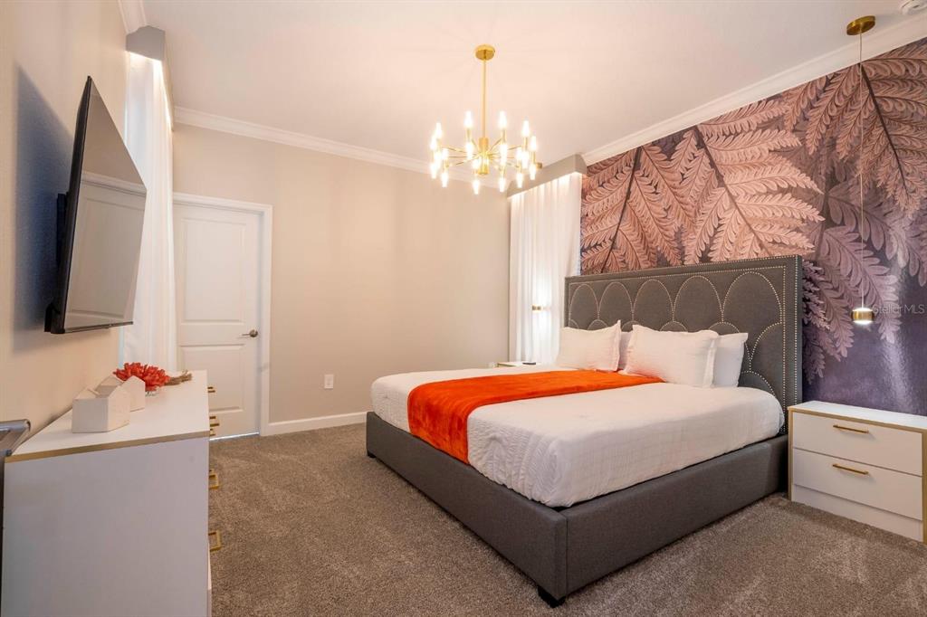 8964 Takeaway Way Davenport, FL 33896 - Photo 41 of 71 a bedroom with a bed dresser and a flat tv screen