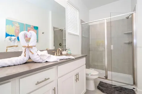 a bathroom with a granite countertop sink mirror and