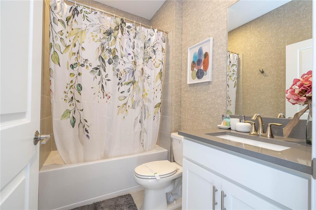 8964 Takeaway Way Davenport, FL 33896 - Photo 50 of 71 a bathroom with a sink a toilet and a bathtub