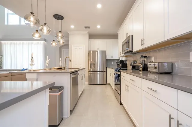 a bedroom with a bed and a chandelier