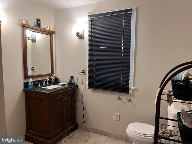 a bathroom with a toilet a sink and mirror