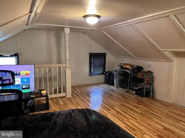 a view of a room with wooden floor