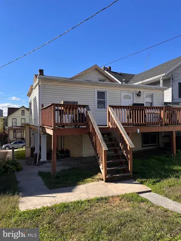 a front view of a house with wooden stairs