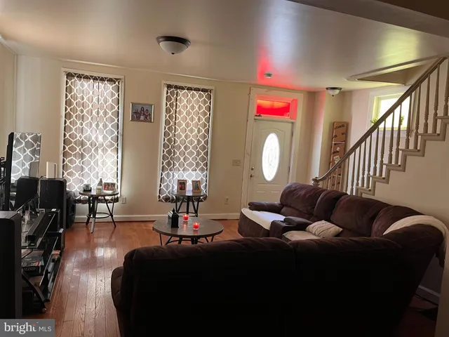 a living room with furniture windows and a flat screen tv