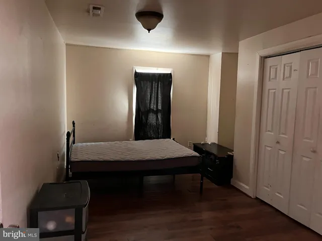 a room with a table chairs and wooden floor