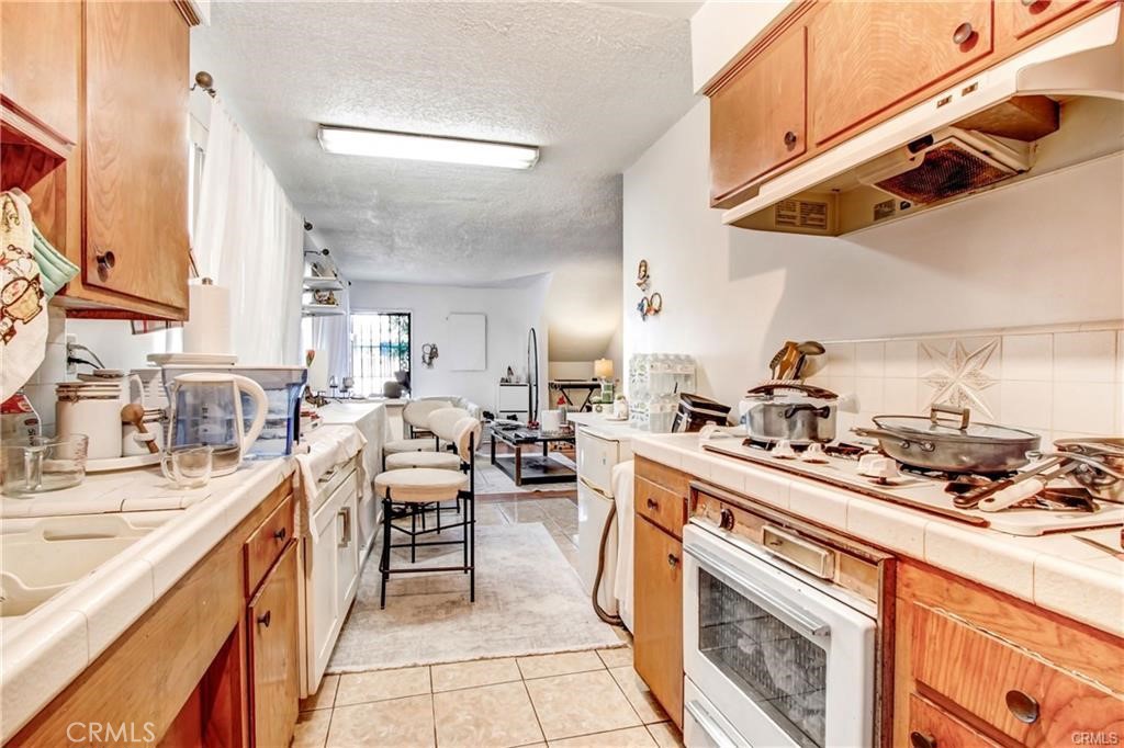 11258 Ohio Avenue Los Angeles, CA 90025 - Photo 4 of 19 a kitchen with a stove a sink and a refrigerator