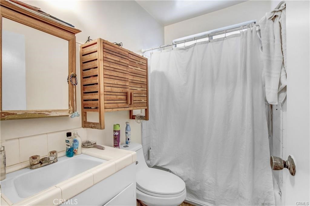 11258 Ohio Avenue Los Angeles, CA 90025 - Photo 5 of 19 a bathroom with a sink a toilet and shower curtain