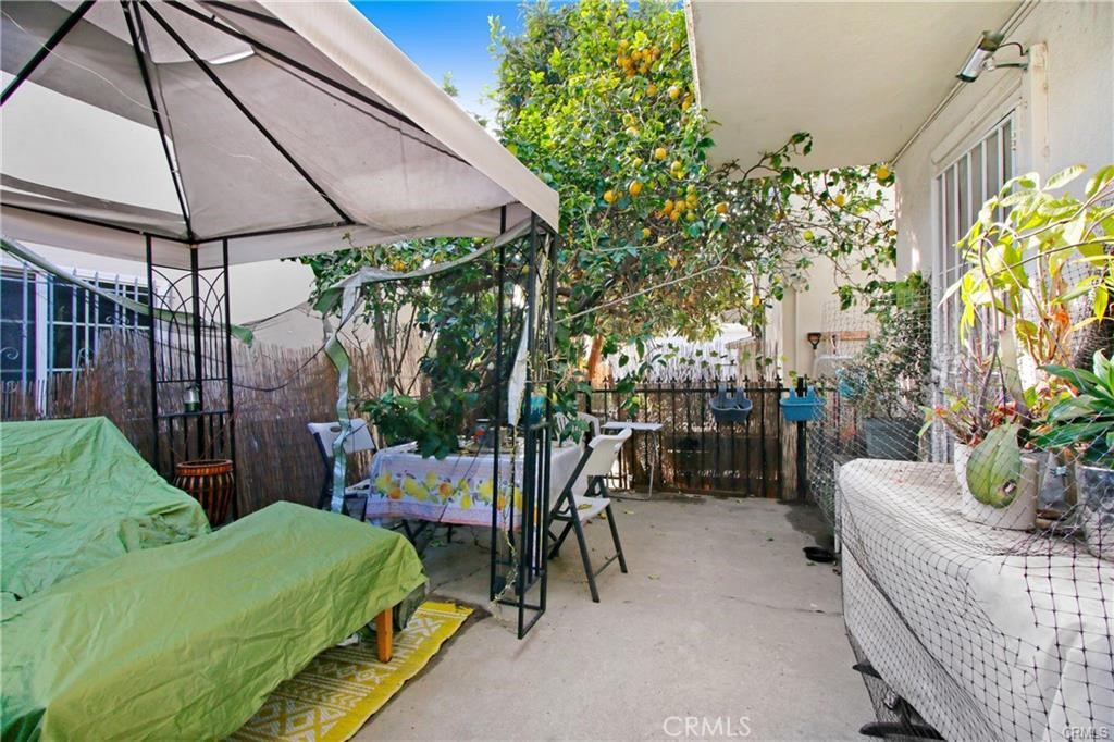 11258 Ohio Avenue Los Angeles, CA 90025 - Photo 6 of 19 a patio with a table and chairs under an umbrella