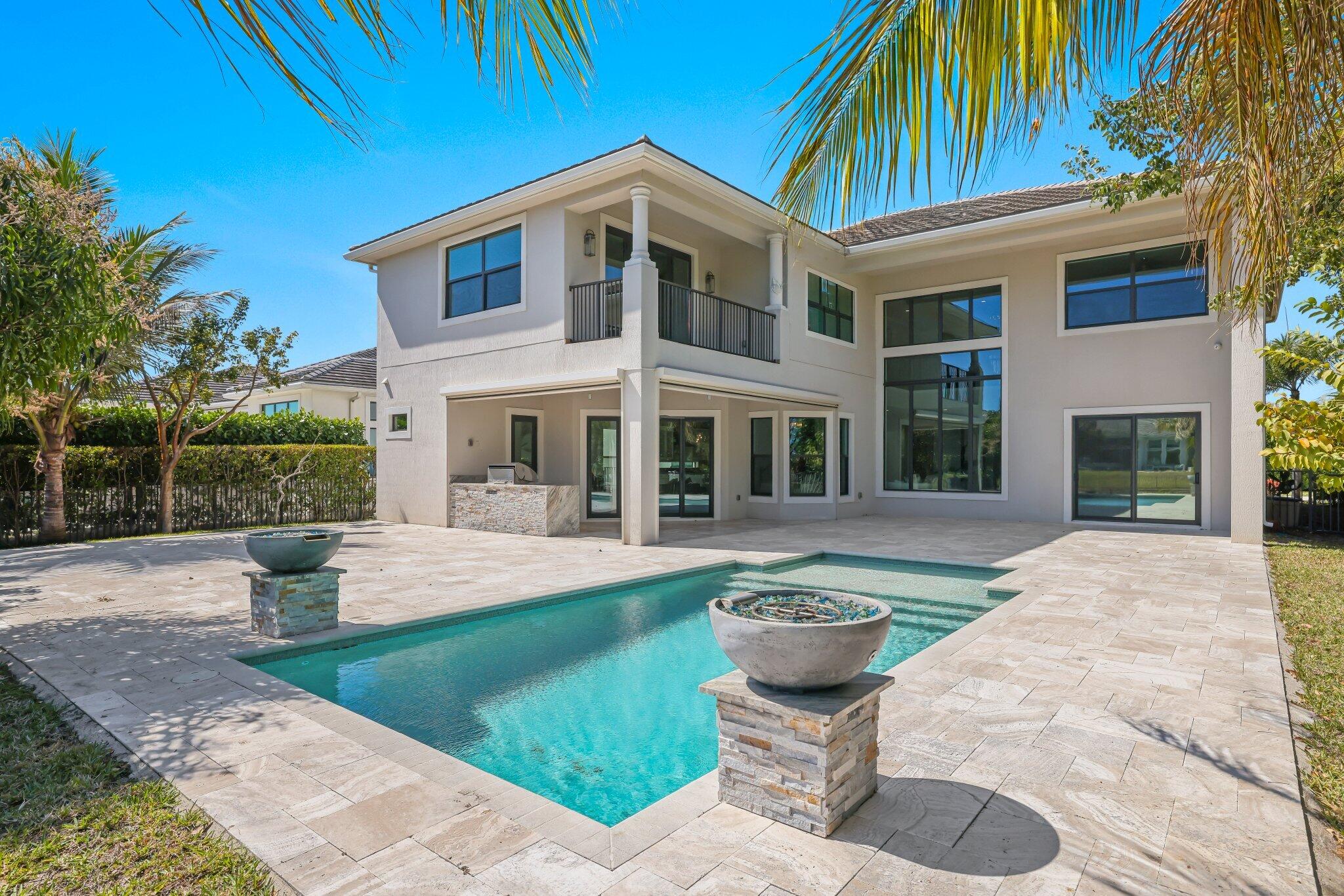 7015 Northwest 27th Avenue Boca Raton, FL 33496 - Photo 1 of 80 a front view of a house with swimming pool having outdoor seating