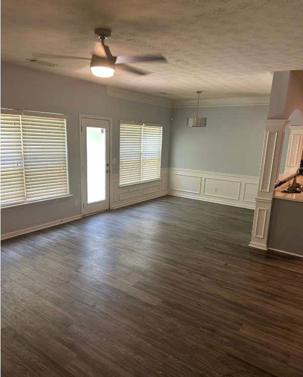 5103 Jack Drive Decatur, GA 30035 - Photo 3 of 34 an empty room with wooden floor chandelier fan and windows