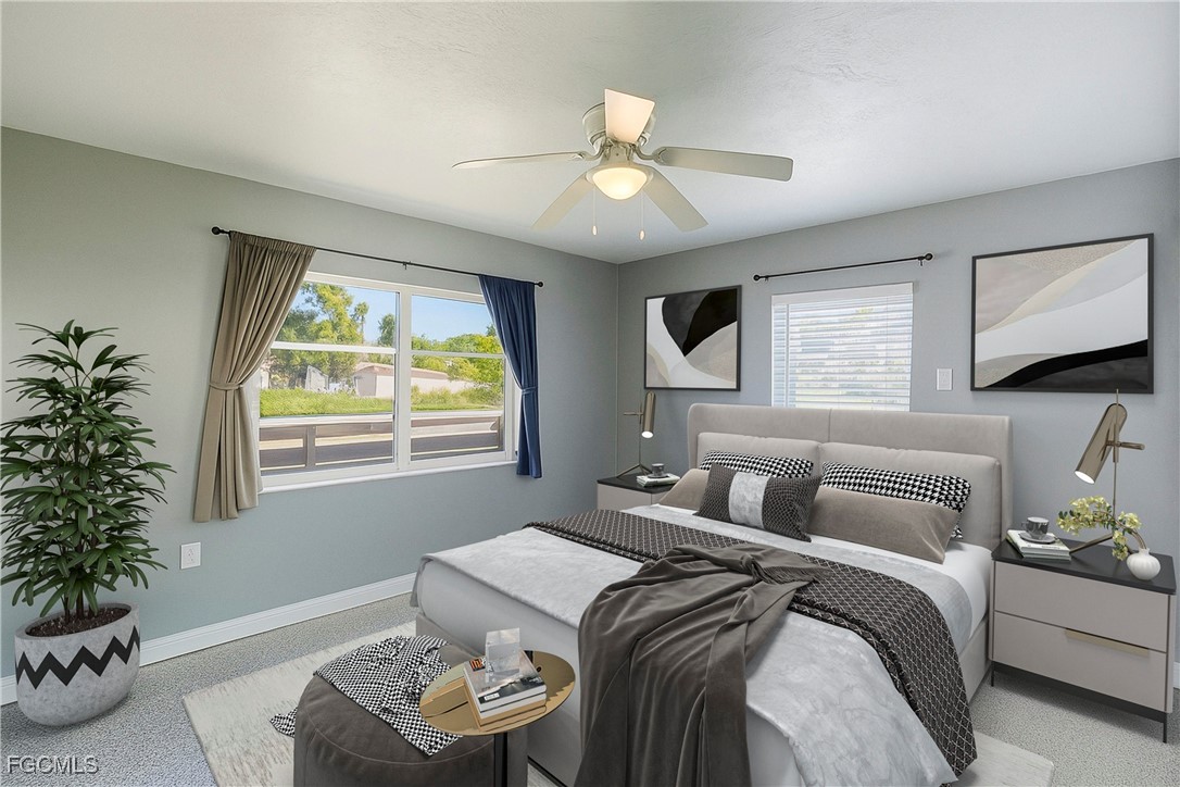 1440 Mandel Road Fort Myers, FL 33919 - Photo 11 of 40 a bedroom with a bed and a chandelier