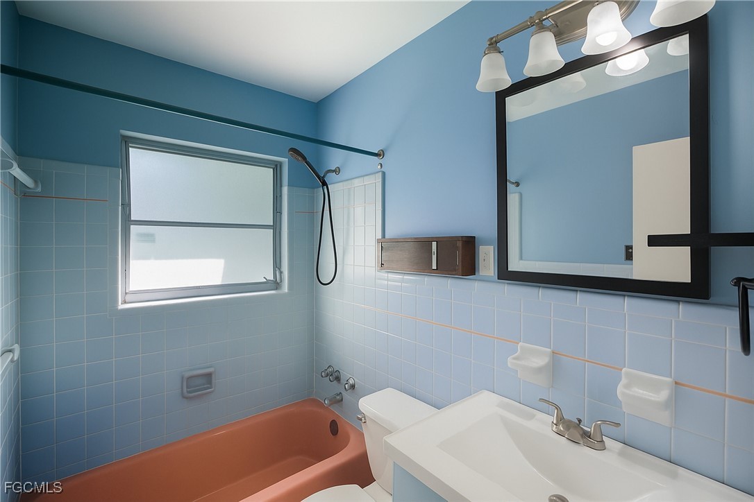 1440 Mandel Road Fort Myers, FL 33919 - Photo 15 of 40 a bathroom with a sink a toilet and mirror