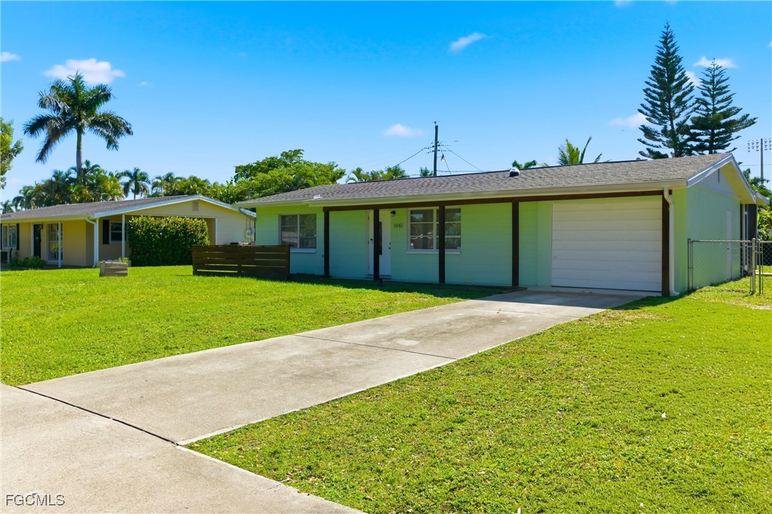 1440 Mandel Road Fort Myers, FL 33919 - Photo 2 of 40 a front view of a house with a garden and yard
