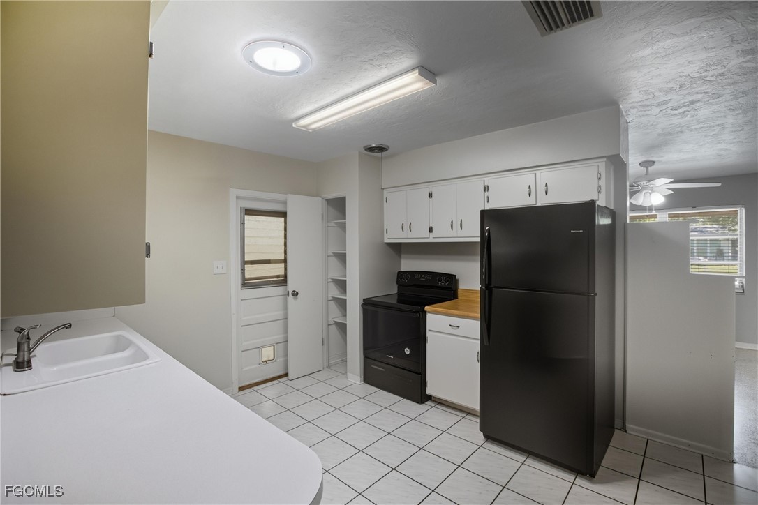 1440 Mandel Road Fort Myers, FL 33919 - Photo 7 of 40 a kitchen with a refrigerator and a sink