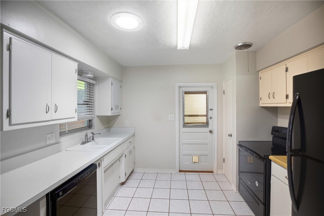 1440 Mandel Road Fort Myers, FL 33919 - Photo 10 of 40 a kitchen with a sink cabinets and refrigerator