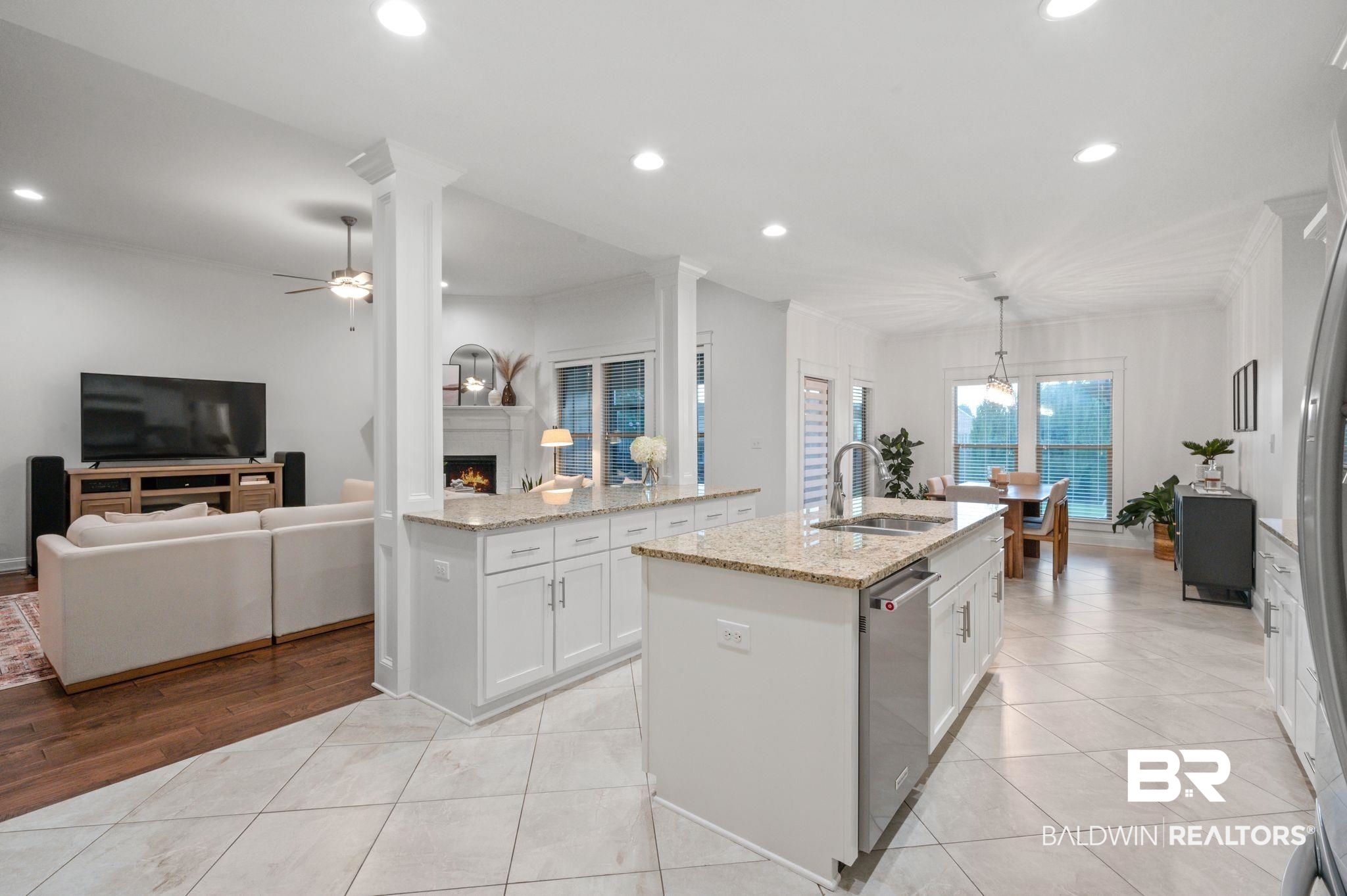 418 Fortune Drive Fairhope, AL 36532 - Photo 18 of 63 Kitchen with sink, a kitchen island with sink, light wood-type flooring, white cabinetry, and ceiling fan