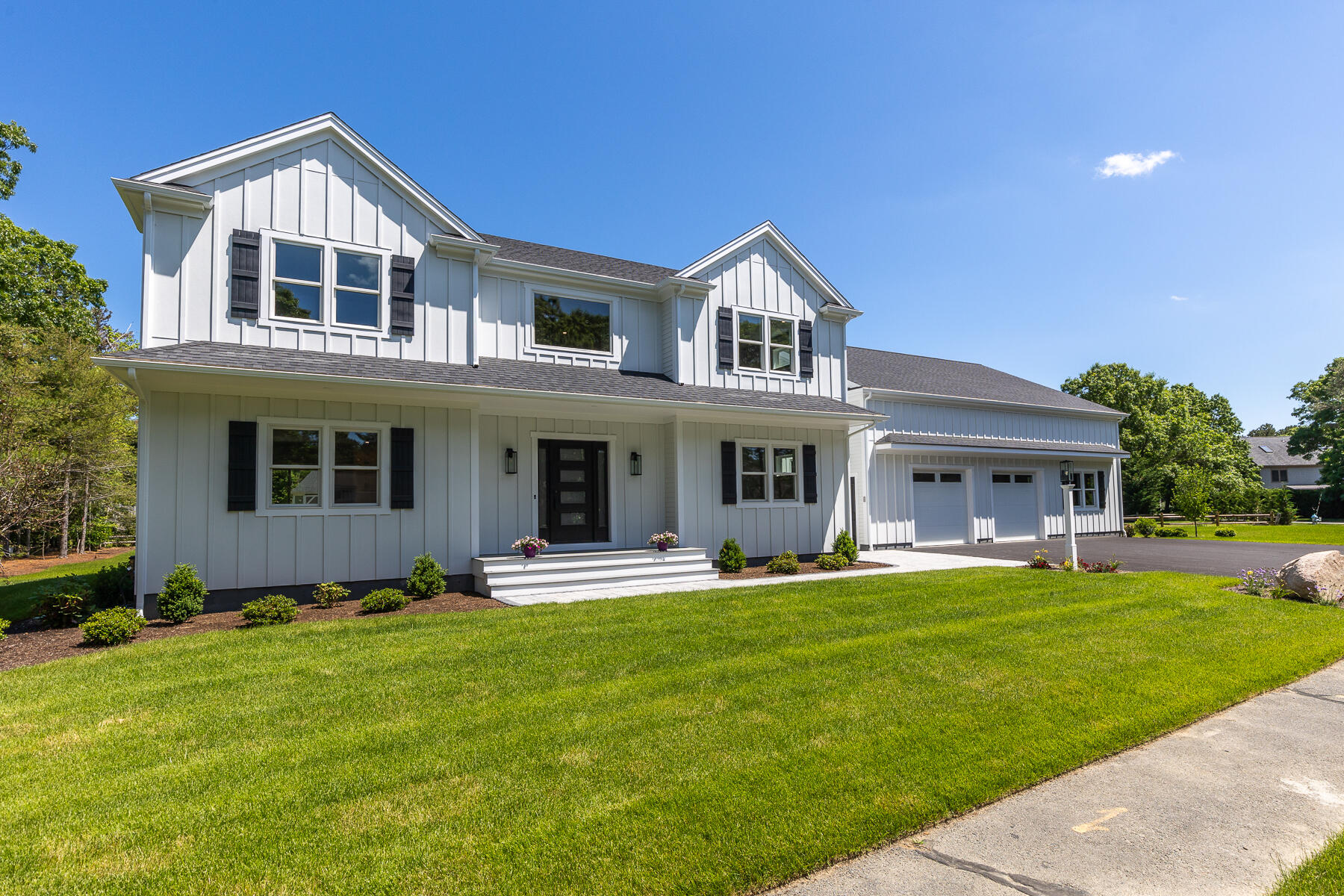 144 Rickenbacker Road East Falmouth, MA 02536 - Photo 2 of 50 a front view of a house with a yard and trees