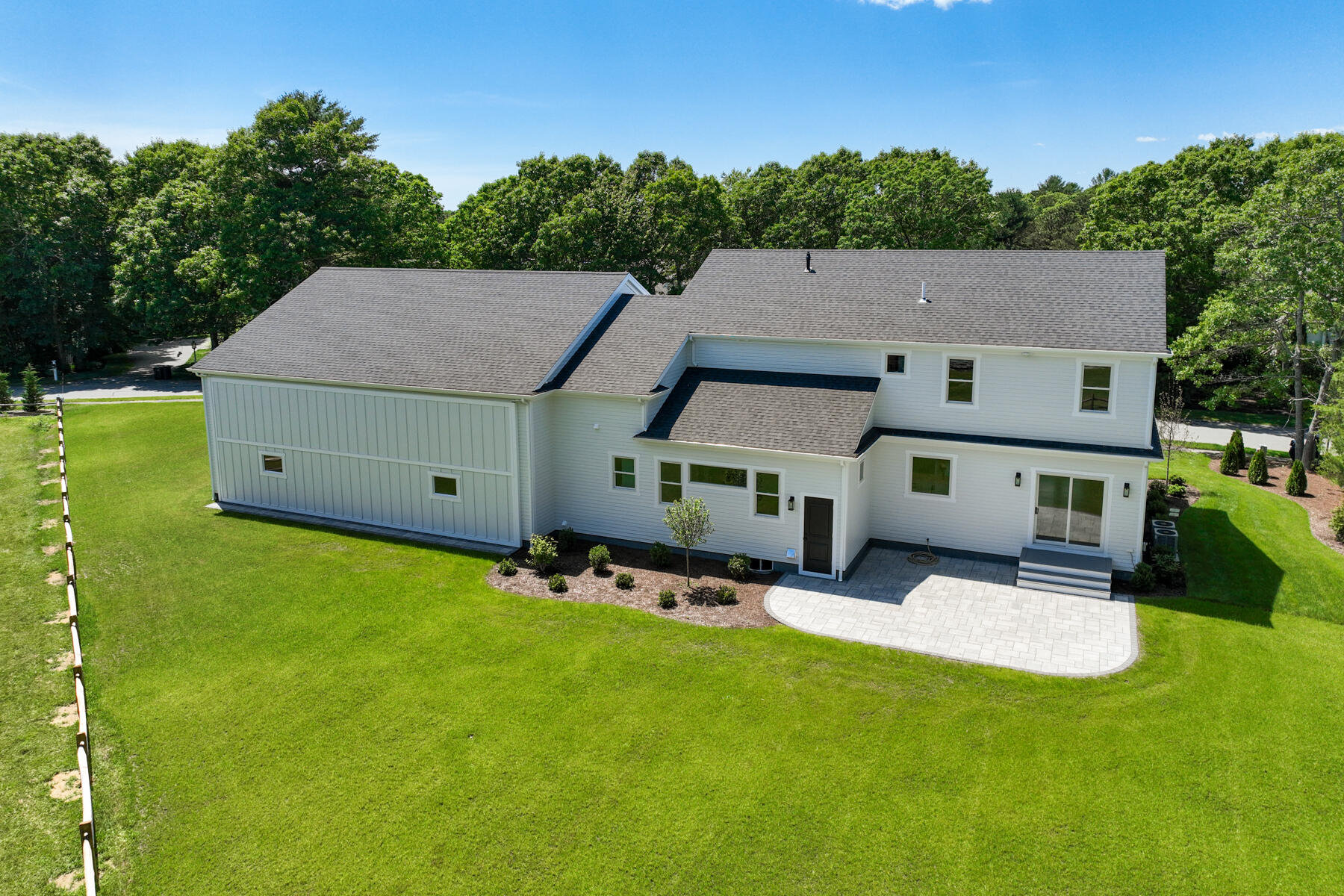 144 Rickenbacker Road East Falmouth, MA 02536 - Photo 45 of 50 an aerial view of a house with table and chairs with wooden fence