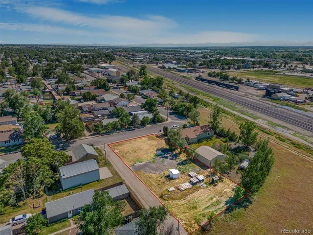 an aerial view of a residential houses with outdoor space