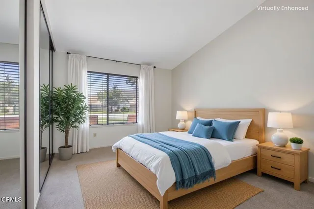 a bedroom with a large bed and a large window