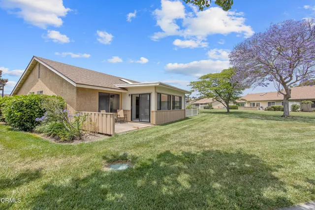 a view of house with yard and green space