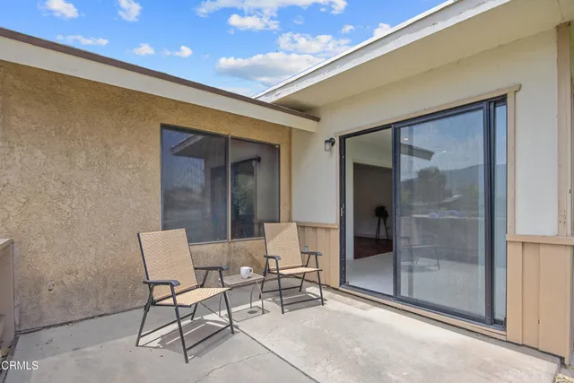 a dining room with furniture and front door