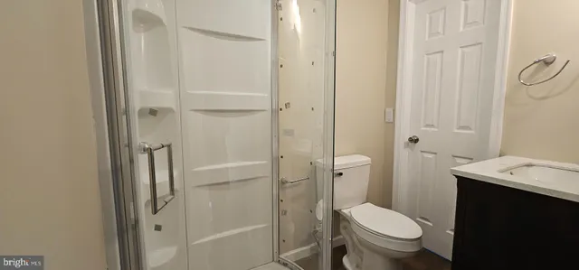 a white toilet sitting next to a bathroom sink