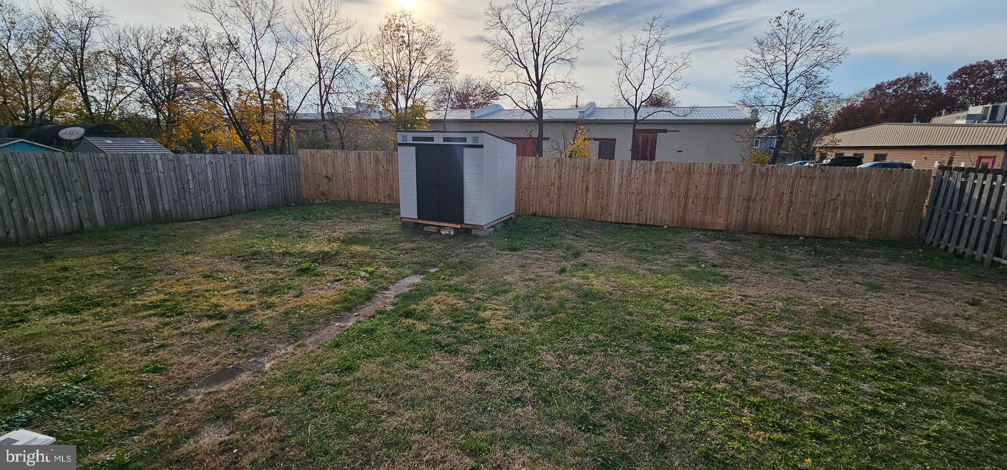 36 Maple Avenue Hatfield, PA 19440 - Photo 23 of 23 a backyard of a house with a small barn and wooden fence