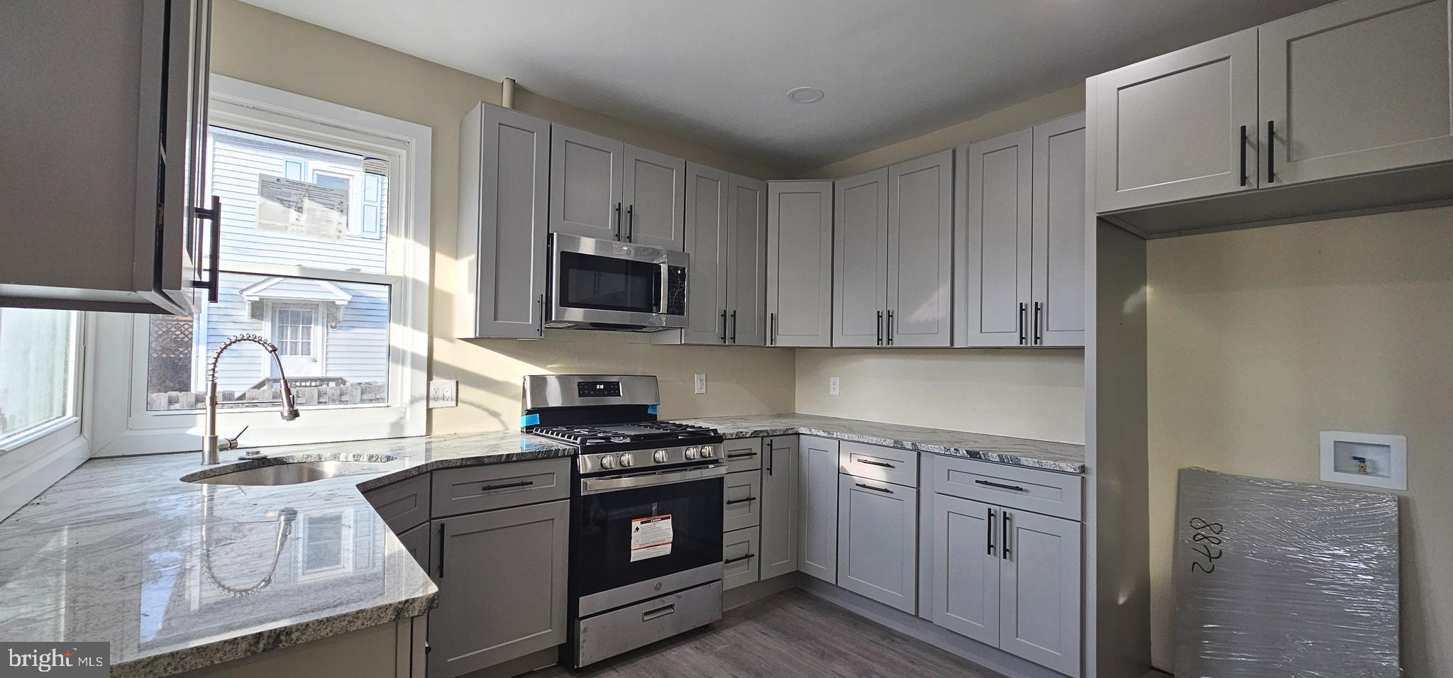 36 Maple Avenue Hatfield, PA 19440 - Photo 6 of 23 a kitchen with stainless steel appliances granite countertop a stove a sink and a refrigerator