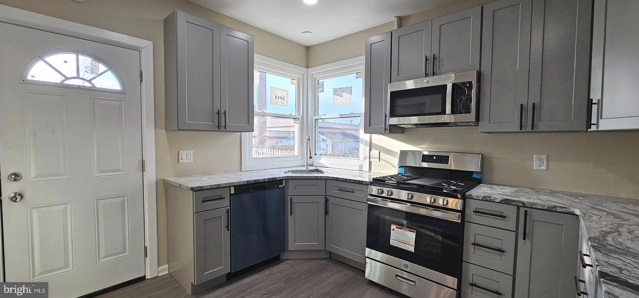 36 Maple Avenue Hatfield, PA 19440 - Photo 7 of 23 a kitchen with stainless steel appliances a stove a microwave and sink