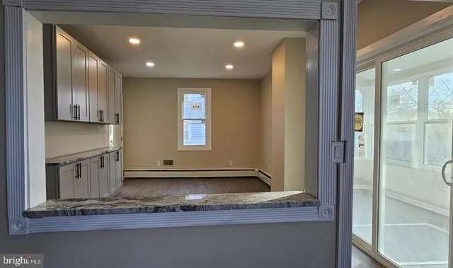 a view of a kitchen with a sink and cabinets