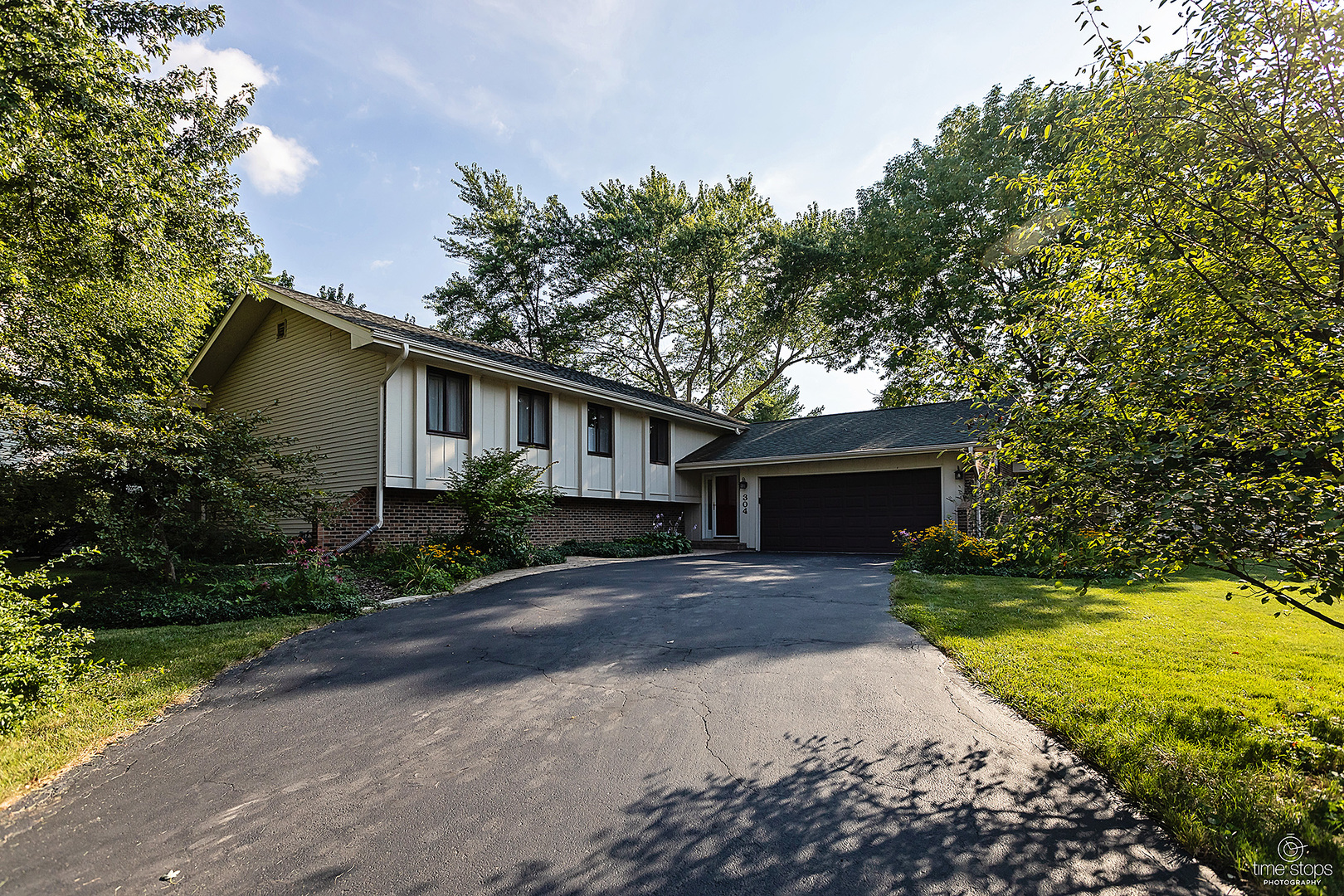 a front view of house with yard and green space