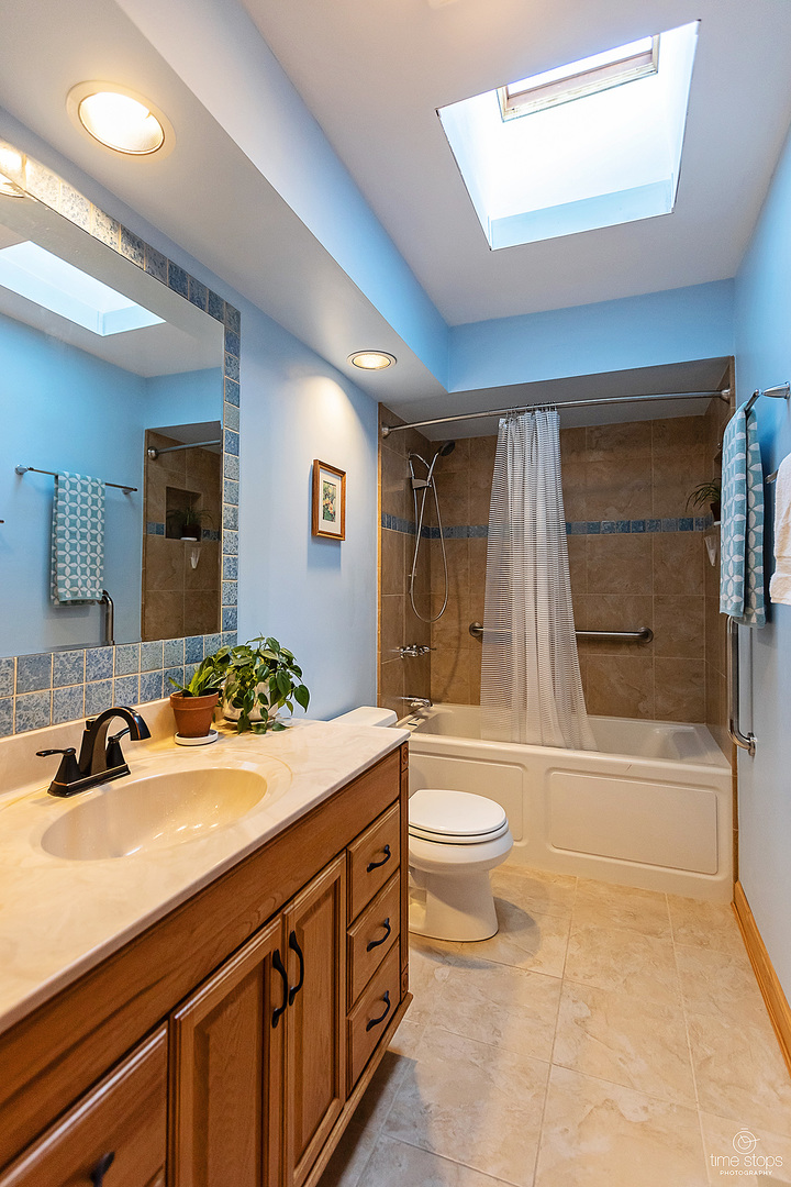304 Warwick Drive Naperville, IL 60565 - Photo 25 of 41 a bathroom with a double vanity sink toilet mirror and bathtub