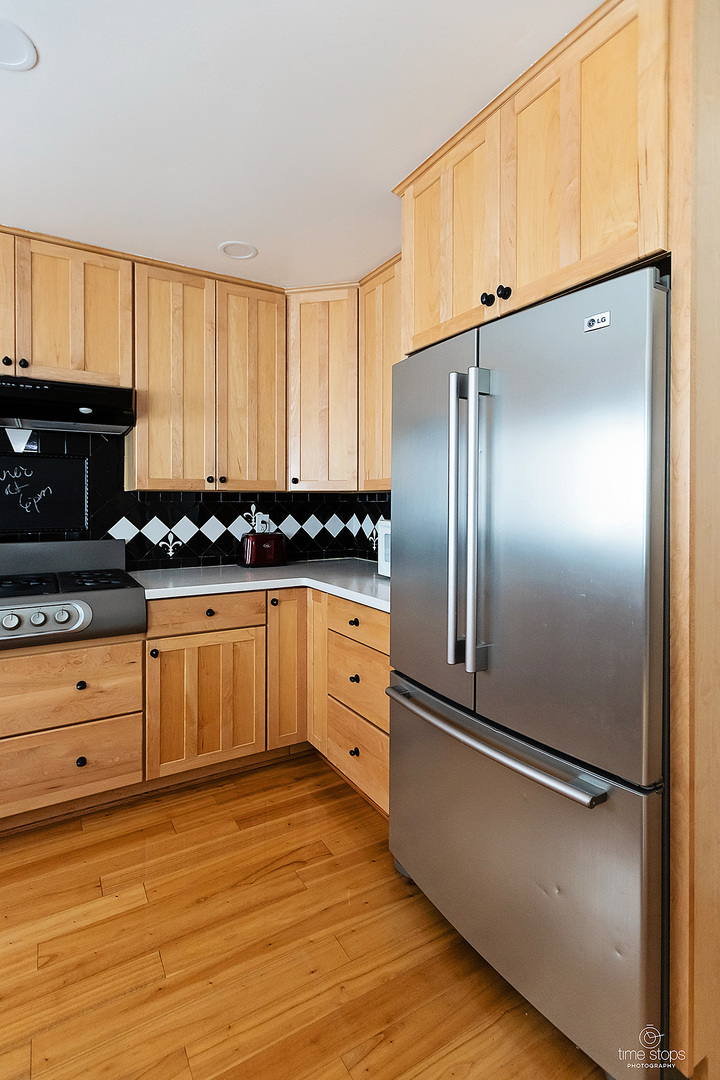 304 Warwick Drive Naperville, IL 60565 - Photo 10 of 41 a kitchen with stainless steel appliances a refrigerator sink and cabinets