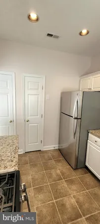 a view of kitchen with granite countertop