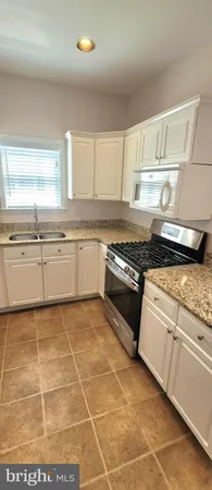 a view of a kitchen with an empty space and window