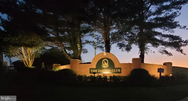 a view of a backyard of a house with table and chairs