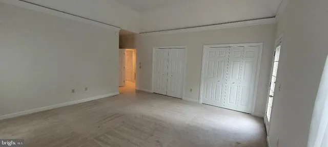 an empty room that has a window in it