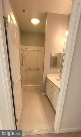 a bathroom with a sink a toilet and a shower