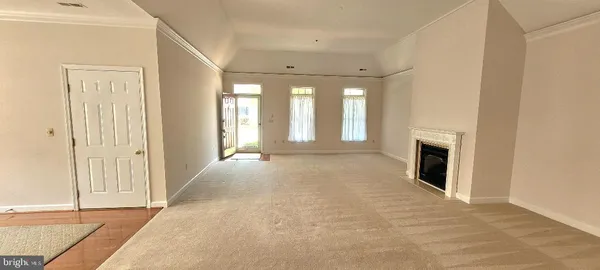 a view of an empty room with a fireplace