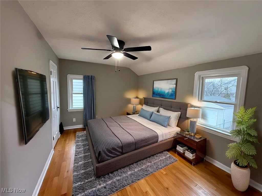 6807 Gerald Avenue Parma, OH 44129 - Photo 19 of 25 Bedroom featuring light wood-style flooring, baseboards, and vaulted ceiling virtually staged
