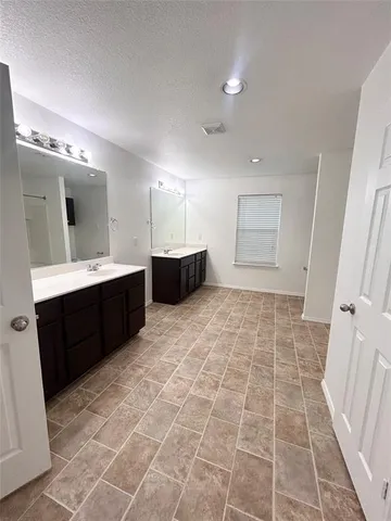 a bathroom with a sink mirror and a shower