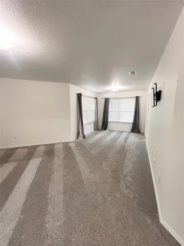 a view of a bedroom with a large bed and a large window