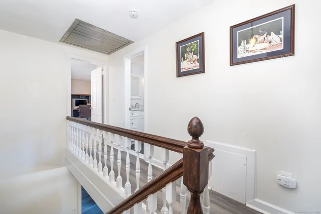 a view of a hallway with paintings on the wall