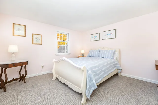 a bedroom with a bed and chair