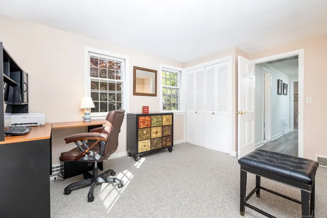 a view of a workspace with a window and lounge chair