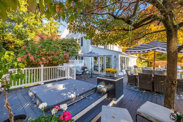 a view of a patio with a table chairs and a fire pit