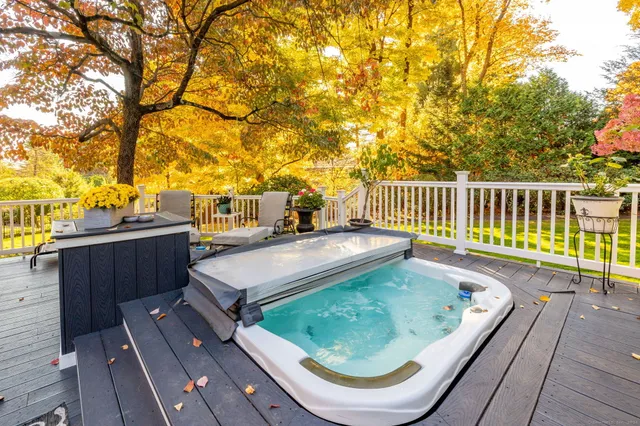 a view of a balcony with wooden floor and fence